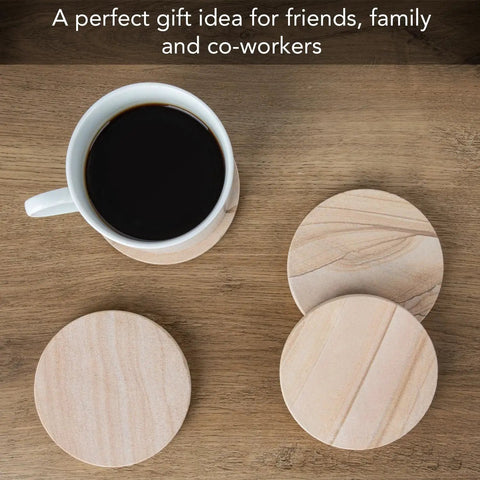 Desert Sandstone Coasters Set with coffee mug, showcasing all natural multicolor stone with unique grain patterns on wooden table.