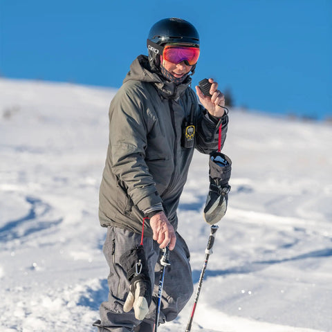 Man using Push To Talk Handheld And Wearable Speaker Microphone Set For GMRS Radios, 4 Pack in snowy landscape