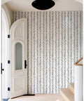 Boho Peel And Stick Chevron Wallpaper Self Adhesive Mural In Black And White Stripes 17.7In By 32.8Ft on entry wall near staircase.