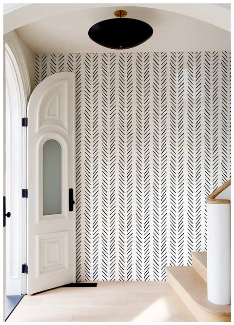 Boho Peel And Stick Chevron Wallpaper Self Adhesive Mural In Black And White Stripes 17.7In By 32.8Ft on entry wall near staircase.