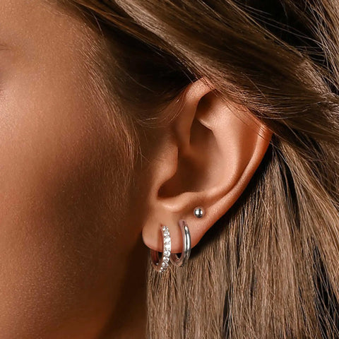 Stainless Steel Earring Set For Women, 10 Pairs, Includes Small Huggie Hoops, CZ Studs, And Glossy Spherical Studs on ear