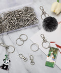 50 Piece Keychain Making Kit With Lobster Claw Clasps And Key Rings For DIY Keychains Jewelry And Lanyards displayed on marble surface