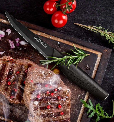 Eight Piece Steak Knife Set With Stainless Steel Serrated Blades, Rust Resistant Nonstick Coating; black handle knife next to steak and herbs