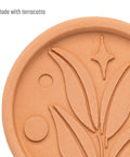 Terracotta Brown Sugar Saver Disc with elegant leaf design, food-safe softener for hard brown sugar, shown up close.