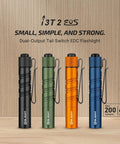 I3T 2 EOS Pocket EDC Flashlight in black, green, orange, and blue with 200 lumen output, dual tail switch, on wooden background.