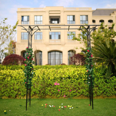 Steel Garden Arch For Climbing Plants 6 Ft 9 In High By 4 Ft 11 In Wide Weather Resistant Black Epoxy Finish Outdoor Yard Arbor Built To Show Off Vines And Flowers Easy Setup For Your Patio Garden Lawn Backyard in front of a building