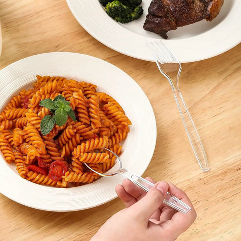 Person using disposable fork from 400 Count Heavy Duty Plastic Utensils Set Disposable Forks And Spoons Party Ready Cutlery For Big Gatherings Crack Resistant And BPA Free Food Grade Silverware For Events Durable Budget Friendly set with plate of pasta