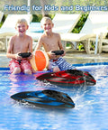 Two kids enjoy Two Pack Remote Control RC Boats For Pool Lake And River With LED Lights Waterproof Self Righting Fast Speed Racing Electric Boats Toy For Kids Ages 8 9 10 Years Old in a pool.