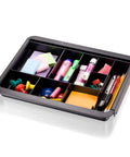 Slick Expandable Drawer Organizer Tray With Adjustable Width And Removable Dividers For Hustle Ready Desk Organization In Smooth Recycled Black Plastic Finish, filled with office supplies and tools.
