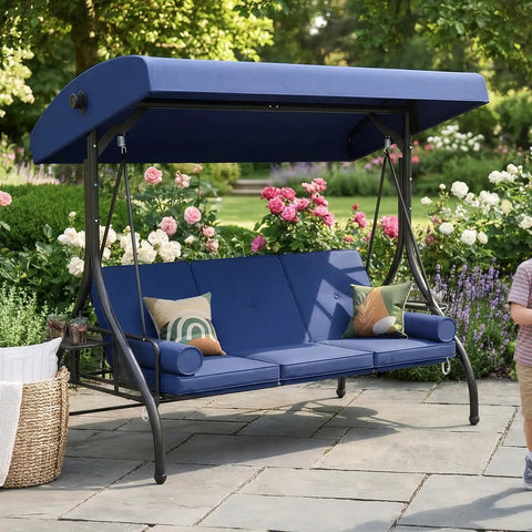 Outdoor Porch Swing With Stand And Canopy For Three Seats Adults Convertible 2 In 1 Swing Bed With Cup Holder Thick Cushions Heavy Duty Steel Frame 800 Lb Weight Capacity Built For Garden Yard Balcony Patio Blue shown in lush garden setting.