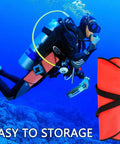 Diver with Big Neon High Visibility 50 Lb Lift Bag For Scuba Diving With Over Pressure Valve, folded for easy storage