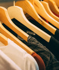 Wooden hangers on a closet rod but "Heavy Duty Closet Shelf And Rod Bracket Set Black 3 Pack Built To Last Supports 12 Inch Deep Shelves" not shown