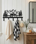 Deer Mountain Metal Key Holder Wall Mount For Rustic Cabin Decor installed on white wall with towels hanging