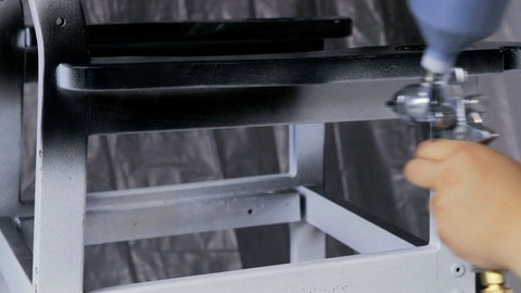 Painting a wooden chair with HVLP Gravity Feed Spray Gun For Auto And Home Garage Projects, Furniture, And Equipment Painting.
