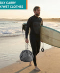 Surfer on beach holding surfboard and Wetsuit Changing Mat And Dry Bag For Surfing And Kayaking All In One 30 Inch Leakproof Gear Mat