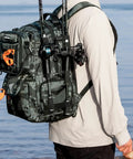 Person wearing a 50L Fishing Tackle Backpack with Removable Bait Binder and Four Tackle Boxes Two Rod Holders Interchangeable Storage System