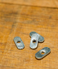 Pack Of 10 Zinc Plated T Track Nuts 1/4 20 Oval Nut Plates Fit Aluminum T Slot Extrusions on wooden surface.