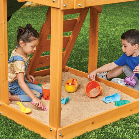 Children playing in sandbox under Weatherproof Wooden Swing Set For Backyard With UV And Mold Protection, Durable Pre Treated Lumber.