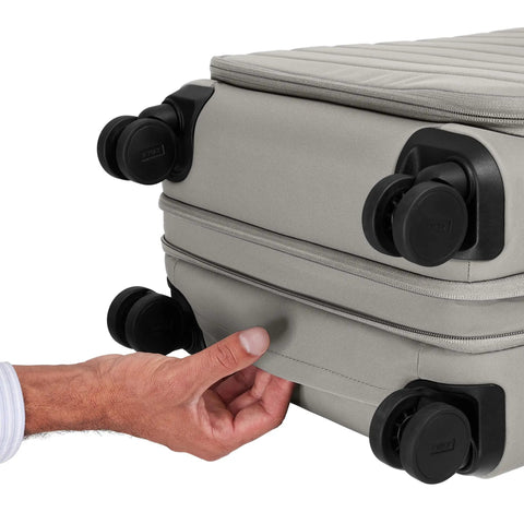 Softside Bigger Carry On Luggage 23 Inch Expandable With Spinner Wheels Built Tough Nylon TSA Accepted Color Matching Padlock Airline Approved For Most Major Airlines Cloud Gray, showing close-up of expansion and wheels