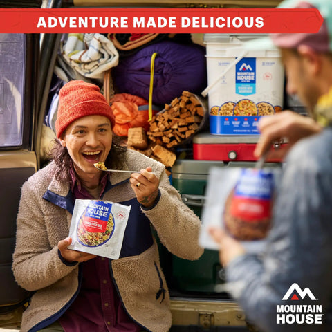 Person enjoying Freeze Dried Breakfast Entree With Biscuits And Gravy For Camping And Backpacking Four Servings Per Pack