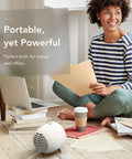 Woman in striped shirt using Portable Space Heater With Detachable Hand Warmer, Instant Warmth In Seconds For Desk Or Small Room at home