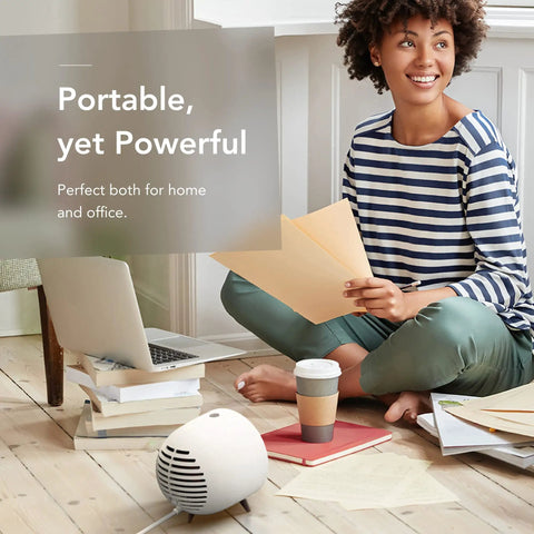 Woman in striped shirt using Portable Space Heater With Detachable Hand Warmer, Instant Warmth In Seconds For Desk Or Small Room at home