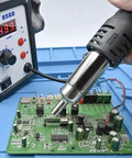 858D Hot Air Desoldering Station With LCD Display 750W in use on a PCB for chip SMD repairs with brushless vortex fan