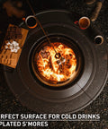 Top view of 42 Inch Fire Pit Surround Tabletop Shield For Wood Burning Pits with s'mores placed nearby, steel frame.