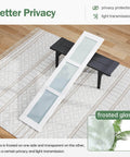 Double 18x84 White Frosted Glass Bifold Barn Door Set panel on a rug, showing frosted glass design for privacy.