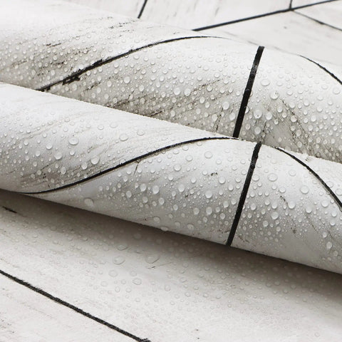 Close-up of roll showing Peel And Stick Wood Wallpaper With Herringbone Pattern DIY Friendly Self Adhesive Removable Grey And White Vintage Wall Covering