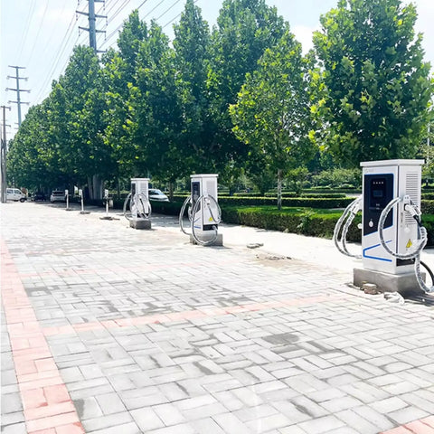 Heavy Duty Level 3 EVSE Charging Station With High Current Floor Pedestal Build Rock Solid DC Fast Charger in a charging area with green trees.