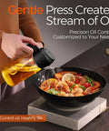 Smooth Operator Sixteen Oz Glass Olive Oil Spray Bottle With Dual Pour And Sprayer Function Drip Free Build For Grilling Roasting And Healthy Cooking Bpa Free Matte Black Kitchen Ace pouring oil over shrimp in a black pan.