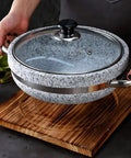 Person holding Heavy Duty Thick Granite Stone Bowl With Wood Base And Glass Lid Induction Ready Donabe Style Pot 30 Cm