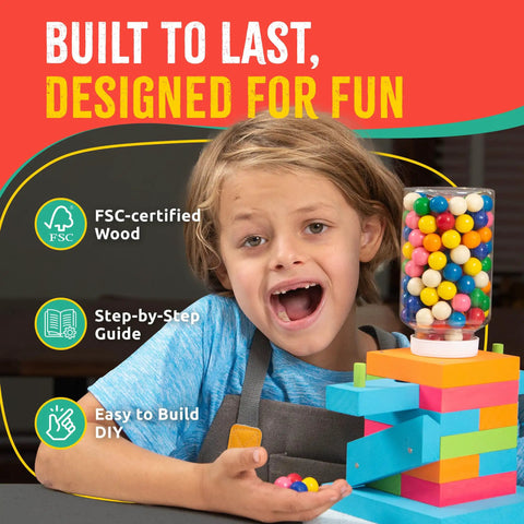 Child with assembled Candy Dispenser Woodworking Kit For Kids A Hands On STEM Building Project With FSC Certified Wood Paints And Tools.
