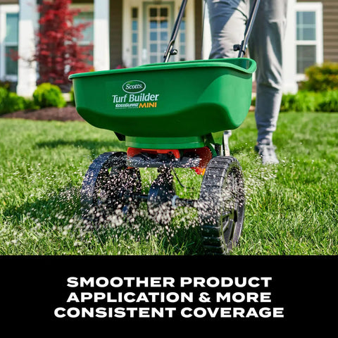 Person using Turf Builder EdgeGuard Mini Broadcast Spreader For Lawns on green lawn