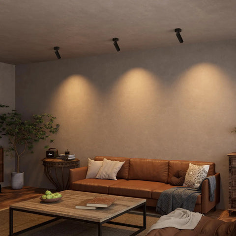 LED Dimmable Ceiling Spotlight For Indoor Accent Lighting in a living room with brown sofa, hardwired surface mount adjustable spotlight