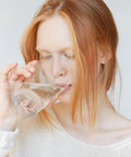 Person drinking water filtered by 3 Pack Water Filter Replacement For Pitchers And Dispensers 4 In 1 Filtration System Cuts Chlorine PFOA PFOS