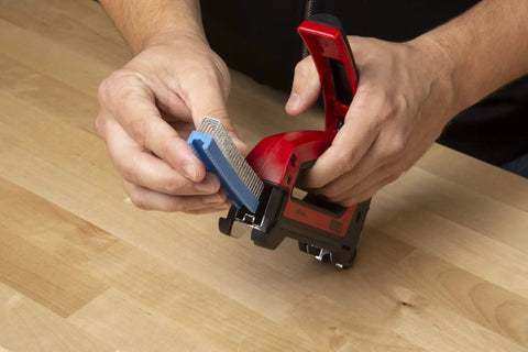 Hands loading staples into Heavy Duty Cable Boss Staple Gun Pro Grade For NM Coax And Low Voltage Wiring Ergonomic Handle Front Grip