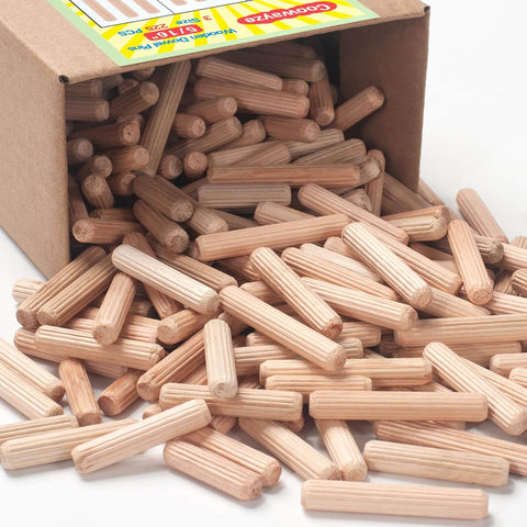 Box spilling out five sixteenths inch wood dowel pins set with 225 pieces kiln dried hardwood fluted beveled for woodworking.