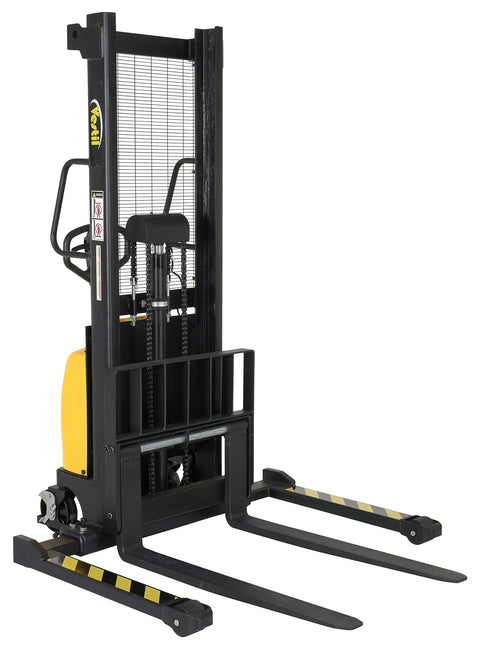 Rock Solid DC Powered Electric Pallet Stacker with adjustable forks and leveling legs shown from the side in a warehouse.