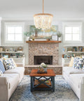 Living room with Bohemian Wood Beaded Pendant Light With White Finish Rustic Three Light Mini Chandelier over coffee table.