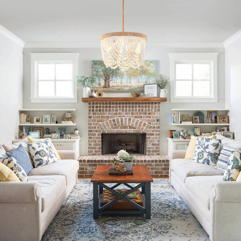 Living room with Bohemian Wood Beaded Pendant Light With White Finish Rustic Three Light Mini Chandelier over coffee table.