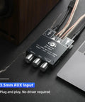 Two Channel 100W Per Side Amplifier Board For DIY Wireless Speakers With Treble And Bass Control DC Nine To Twenty Four Volt Bluetooth And AUX Inputs Password Free Stereo Amp Board shown connected to a laptop and speaker