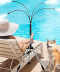 Standing Misters For Outdoor Cooling On The Go Adjustable Four Point One Foot Misting System With Four Spray Heads And Twenty Six Point Two Foot Hose Portable Cooling For Camping, Pool, Beach And Garden BBQ shown by poolside setup with dog and sunbathing person.