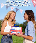 Two women exchanging a Fourth Of July Gel Nail Polish Kit With UV Light And 6 Festive Red White Blue Shades outdoors.
