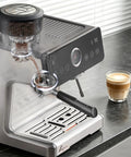 One Touch Auto Grind Espresso Machine With Smart Dosing And Brushed Stainless Steel Finish, grinding coffee with a cup of latte.