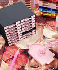 All-In-One 16-Drawer Diamond Art Tray Organizer Rack For Diamond Painting Supplies, Diamond Drill Storage Box, DIY Art Tools And Accessories, Solid Black Organizer For Color Sorting, Beads, And Craft Tools, shown with pink trays and beads.