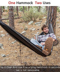 Person relaxing in Double Tree Hammock With Built In Net For Camping And Travel, set up in forest with practical strap system.