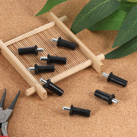 8 Piece Black Metal Cabinet Door Damper Pins Spring Loaded Telescopic Pivot Pins For Cabinet Doors And Shutters Furniture Repair And Maintenance Kit For Quick Home Repairs with pliers and plant leaves background