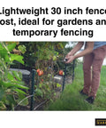 Person installing 30 Inch Garden Fence Post 25 Pack For Gardens And Temporary Fencing Lightweight Green Posts in garden